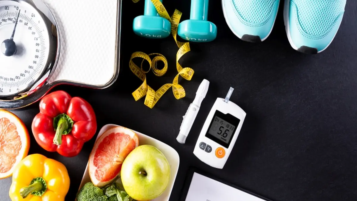 World diabetes day, Healthcare and medical concept. Healthy food including fresh fruits, vegetables, weight scale, sports shoes, dumbells, measure tape and diabetic measurement set on black background.