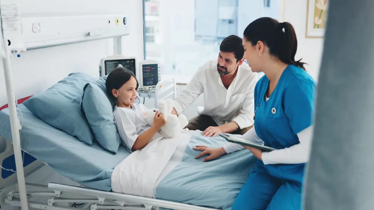 Kind im Krankenhausbett mit Pflegekraft und erwachsener Begleitperson bei der Betreuung