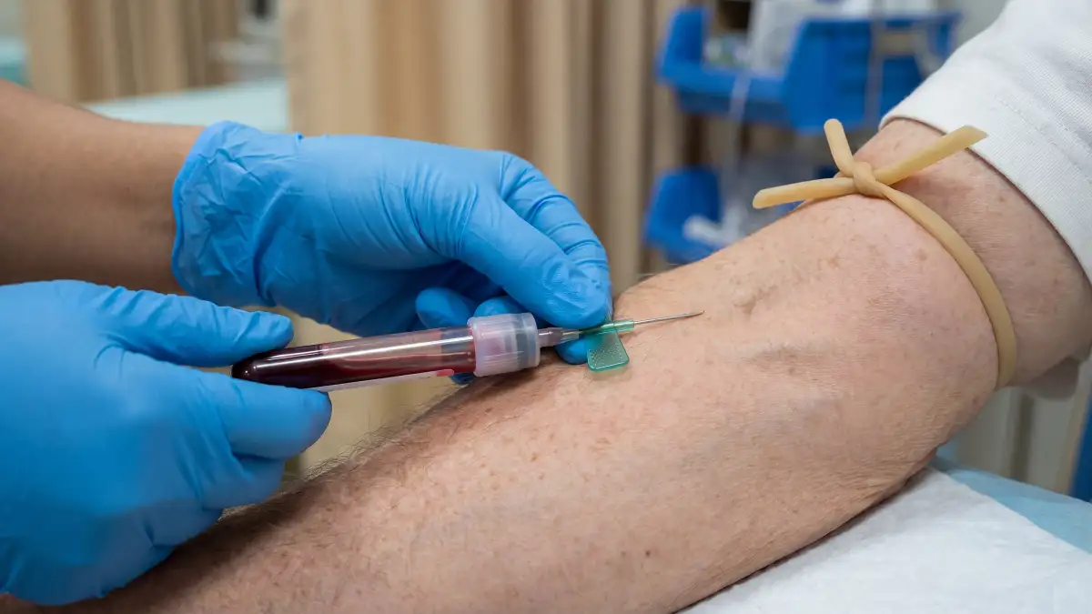 Einem Patienten wird in der Armbeuge Blut abgenommen.